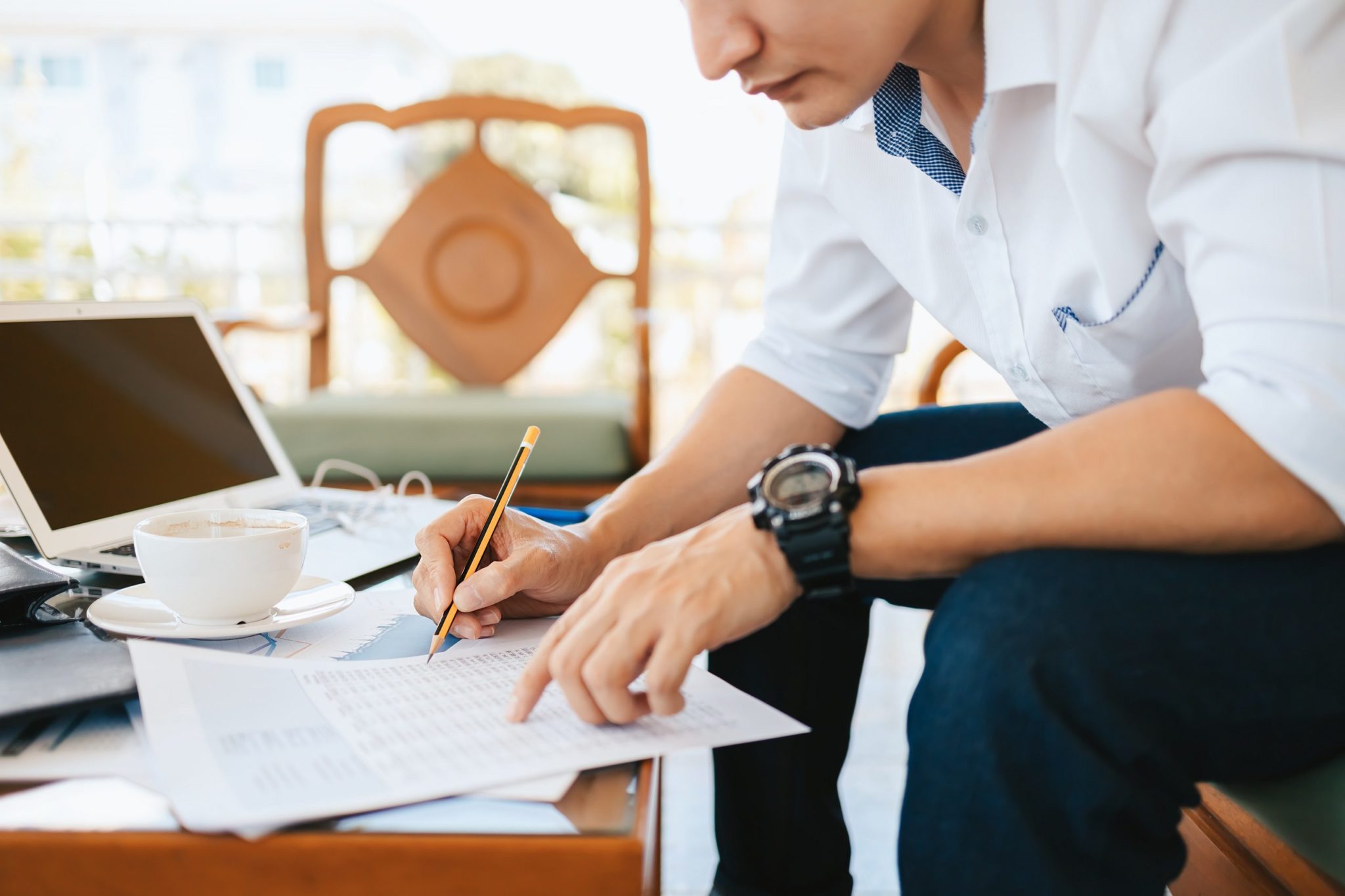 Administrator businessman making report, calculating balance. Business analyzing income charts, graphs and data on the table.