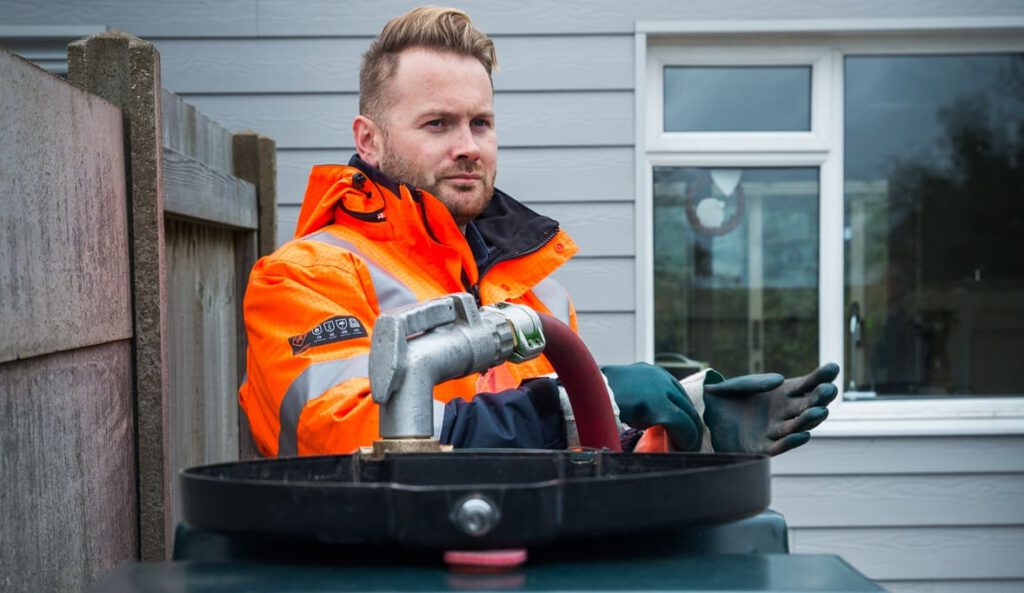 An HVO supplier fills a domestic liquid fuel tank.