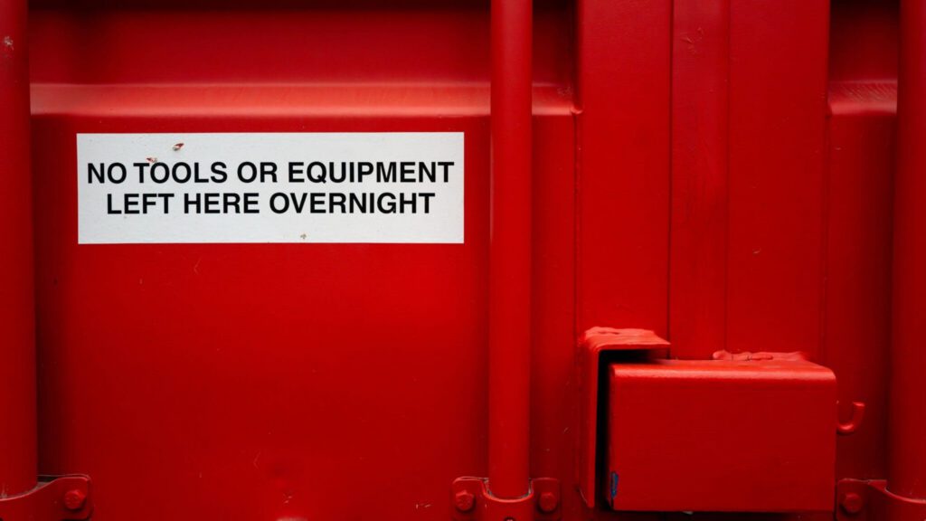 container with signs saying 'no tools or equipment left overnight'